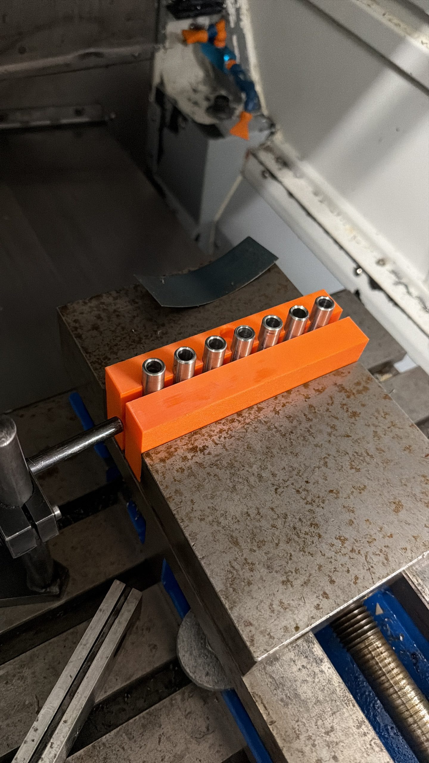 3D printed vise jaw holding stainless steel tubes securely for machining operations