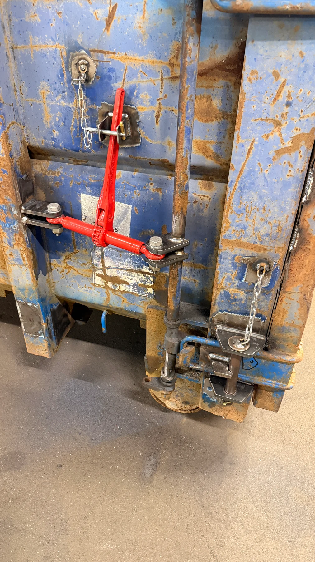 Scrap skip door-closing and locking mechanism reinforced by Wards Welding and Fabrications