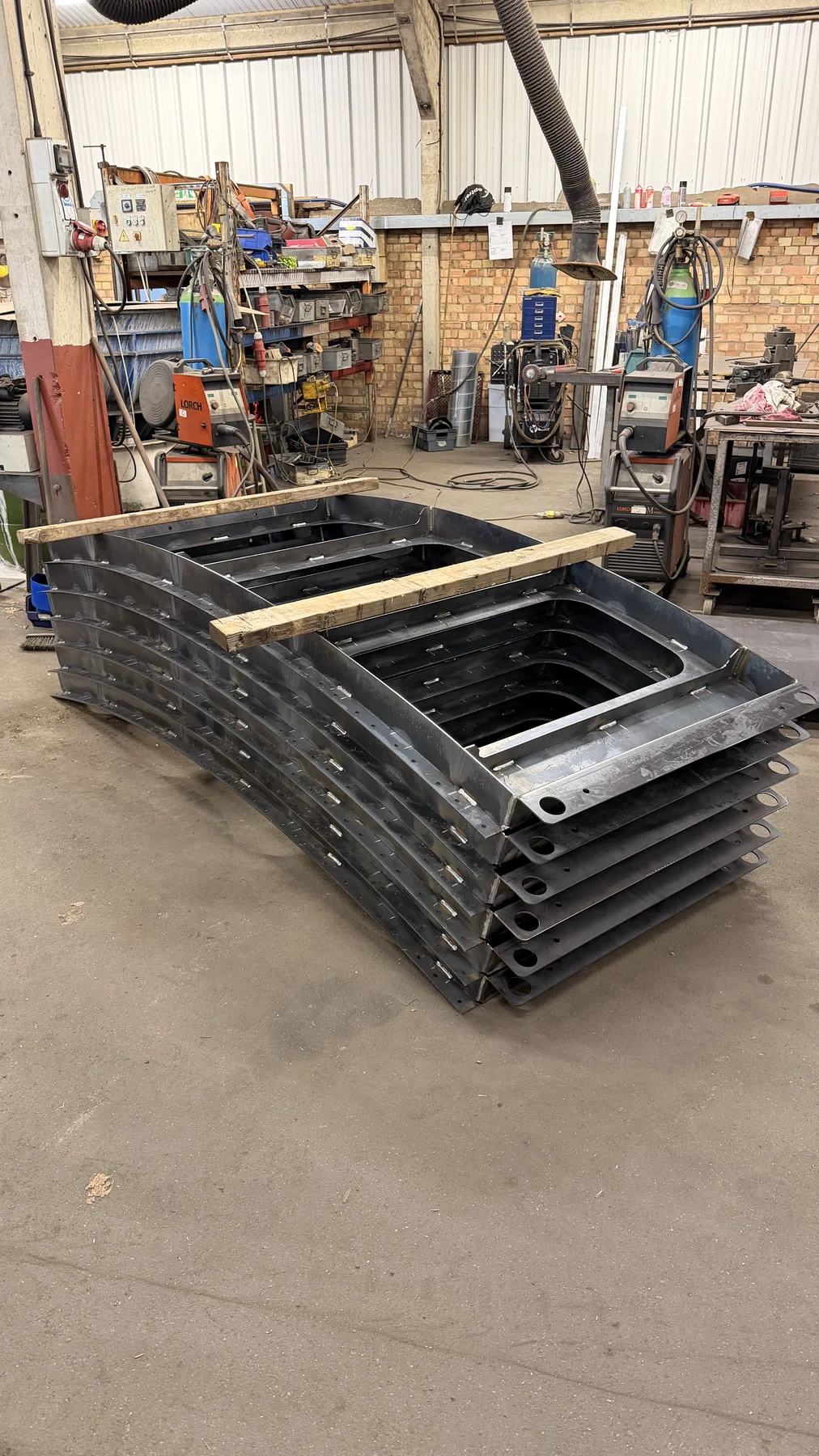 Stack of fabricated steel frames and trays at Wards welding and fabrication Milton Keynes workshop
